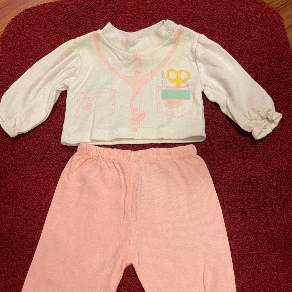 Hopscotch infant two-piece (0-6 months). Dominant colors pink and white.
